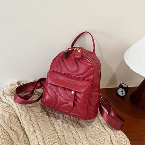 Mini burgundy leather backpack with quilted wave texture and versatile shoulder straps