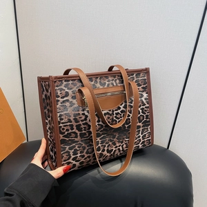 Large leopard print tote bag with brown leather handles and side zipper pocket