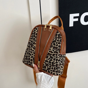 Fashionable leopard print backpack for women with gold zippers and brown leather trim