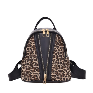Fashionable leopard print backpack with gold V-shaped zippers and black leather trim