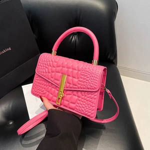 Hot pink crocodile textured handbag with golden metal lock and round top handle