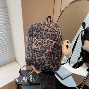 Mini leopard print backpack for women with a cute white plush ghost keychain