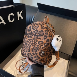 Mini leopard print backpack with plush ghost charm inside a premium black gift box