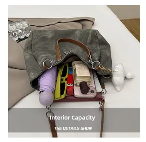 Top-down view of spacious dark grey canvas tote interior with daily essentials and accessories