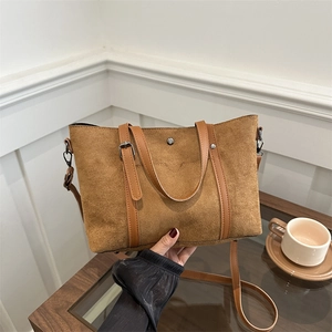 Brown matte suede tote bag with leather handles and silver hardware for autumn winter 2024