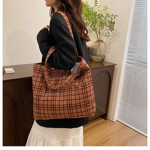 Retro plaid oversized tote bag shown on model in a cozy interior setting for daily wear