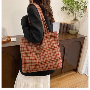 Detail of colorful plaid tote bag made of thick tweed material for winter styling