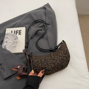 Leopard-Print-Halbmondtasche mit einem süßen Dackel-Lederanhänger im Detail gezeigt