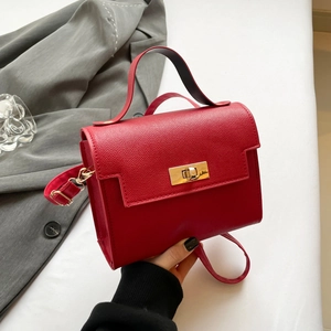 Mini red lychee grain leather handbag with gold metal clasp and adjustable shoulder strap