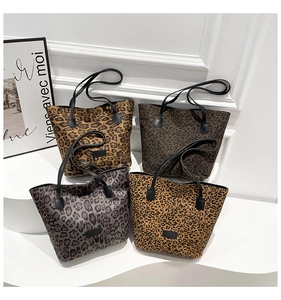 Collection of four large leopard print tote bags in brown, coffee, and grey patterns
