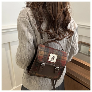 Detail of British style plaid backpack with bear embroidery on leather flap for women