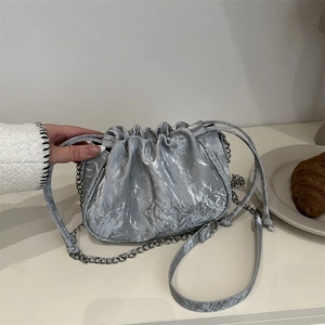 Silver pleated cloud bag with metallic finish and chain strap for summer styling