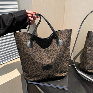 Chic leopard print tote bag with black leather handles for stylish daily commuting