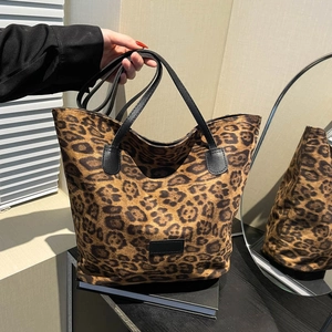 Classic leopard print tote bag with black leather handles for stylish everyday use