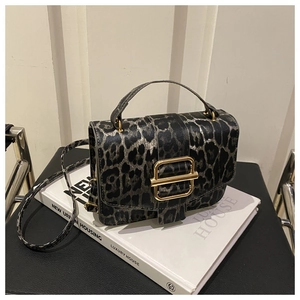 Détail d'un sac à bandoulière léopard tendance avec une boucle en métal doré chic