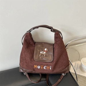 Vintage brown crossbody bag with puppy embroidery and MUTEHI lettering in a cafe setting