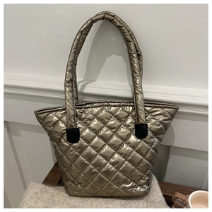 Close-up of metallic quilted puffer tote bag with diamond stitching and padded handles