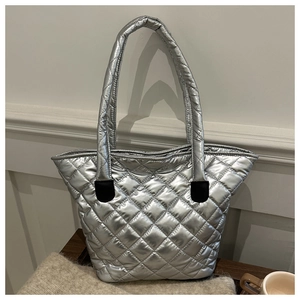 Close-up of metallic silver quilted tote bag with diamond stitching and modern design