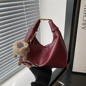 Vintage burgundy leather hobo bag with gold handle and cute plush charm pendant