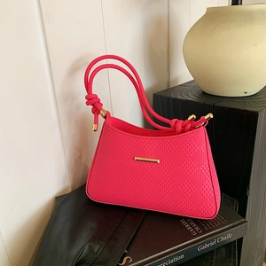 Premium hot pink woven shoulder bag with geometric texture and gold metal accents