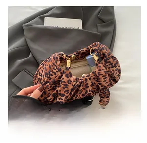 Leopard print handbag interior view showcasing spacious storage and gold hardware detail