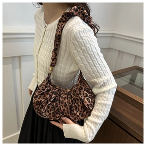 Chic leopard print crescent bag with pleated handle shown on model for size and fit guide