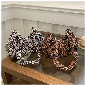 Detail of leopard print ruched handbags in grey and brown with golden metal hardware