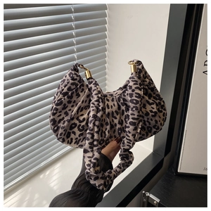 Detail of leopard print crescent bag with pleats and gold hardware detail