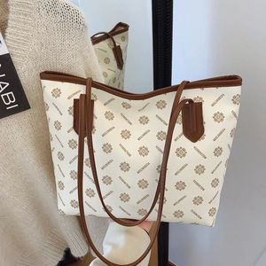 Chic cream tote bag with vintage floral print and dark brown leather straps for commuting