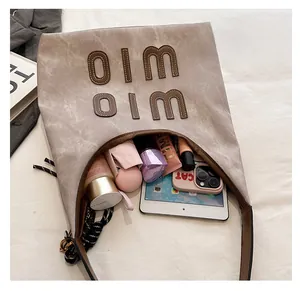 Top-down view of a spacious khaki Hobo tote bag showing iPad and daily essentials inside