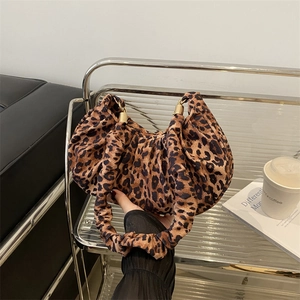 Chic leopard print crescent handbag with scrunchie handle and gold ring detail