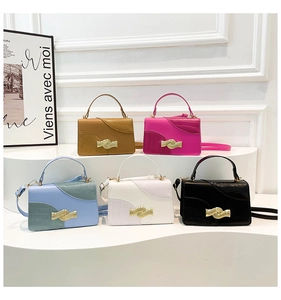 Detailed close-up of colorful crocodile texture purses with gold wavy metal clasps
