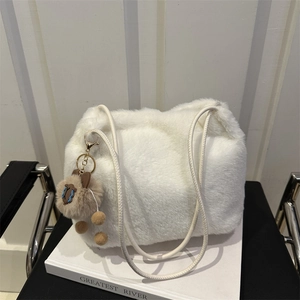 Plush faux fur shoulder bag in white with leather straps and a brown pom-pom charm