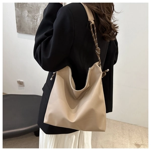 Detail view of the khaki hobo tote bag featuring a stylish knot shoulder strap design