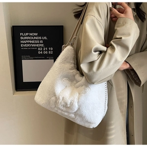 Detail of white plush tote bag with cartoon design and silver chain strap for winter fashion