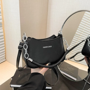 Minimalist black crescent moon handbag with silver chain and white fashion typography