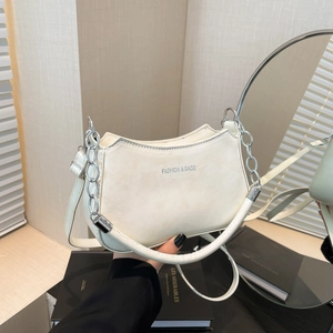 Chic white crescent shoulder bag with silver chain and leather strap in soft lighting