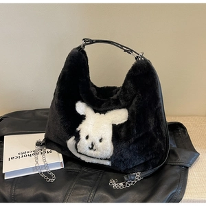 Detail of plush black tote with cute bunny face, leather strap and silver chain accent