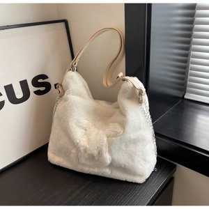 Close-up of white plush tote bag with bunny motif, leather strap and metal chain detail