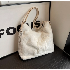 Detail of white faux rabbit fur tote bag featuring a cute 3D bunny relief and leather strap