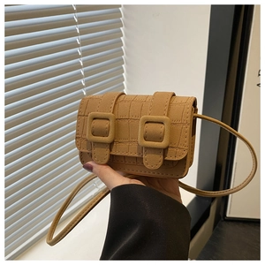 Detail of camel brown faux crocodile flap bag with vintage buckles and slim shoulder strap