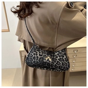 Leopard print underarm bag with gold bow buckle styled with a khaki trench coat