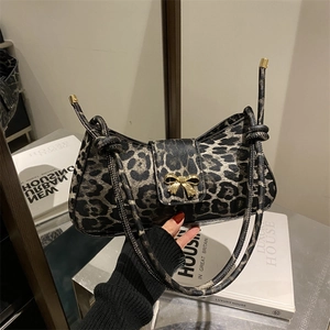 Chic leopard print underarm bag with gold bow clasp and stylish knotted shoulder strap