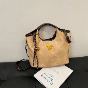 Fashionable khaki bucket bag with brown leather trim and golden triangle hardware