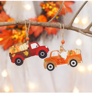 Close-up of wooden harvest truck ornaments hanging on branches with warm autumn bokeh