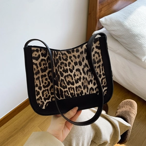 Chic leopard print tote bag with black leather trim and slim shoulder straps