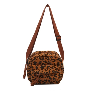 Fashionable leopard print corduroy crossbody bag with adjustable brown strap on white background