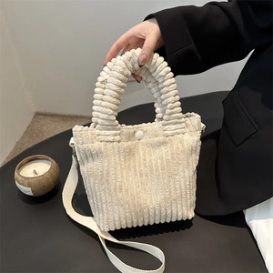 Plush corduroy bucket bag in beige with ruffled handle and adjustable strap
