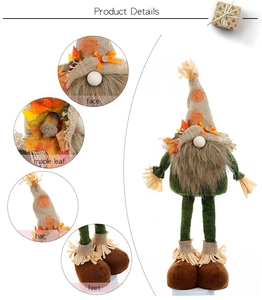 Detail view of harvest gnome showing maple leaf, acorn accents, and plush fabric texture