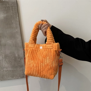 Orange corduroy bucket bag with handle and adjustable strap for winter fashion